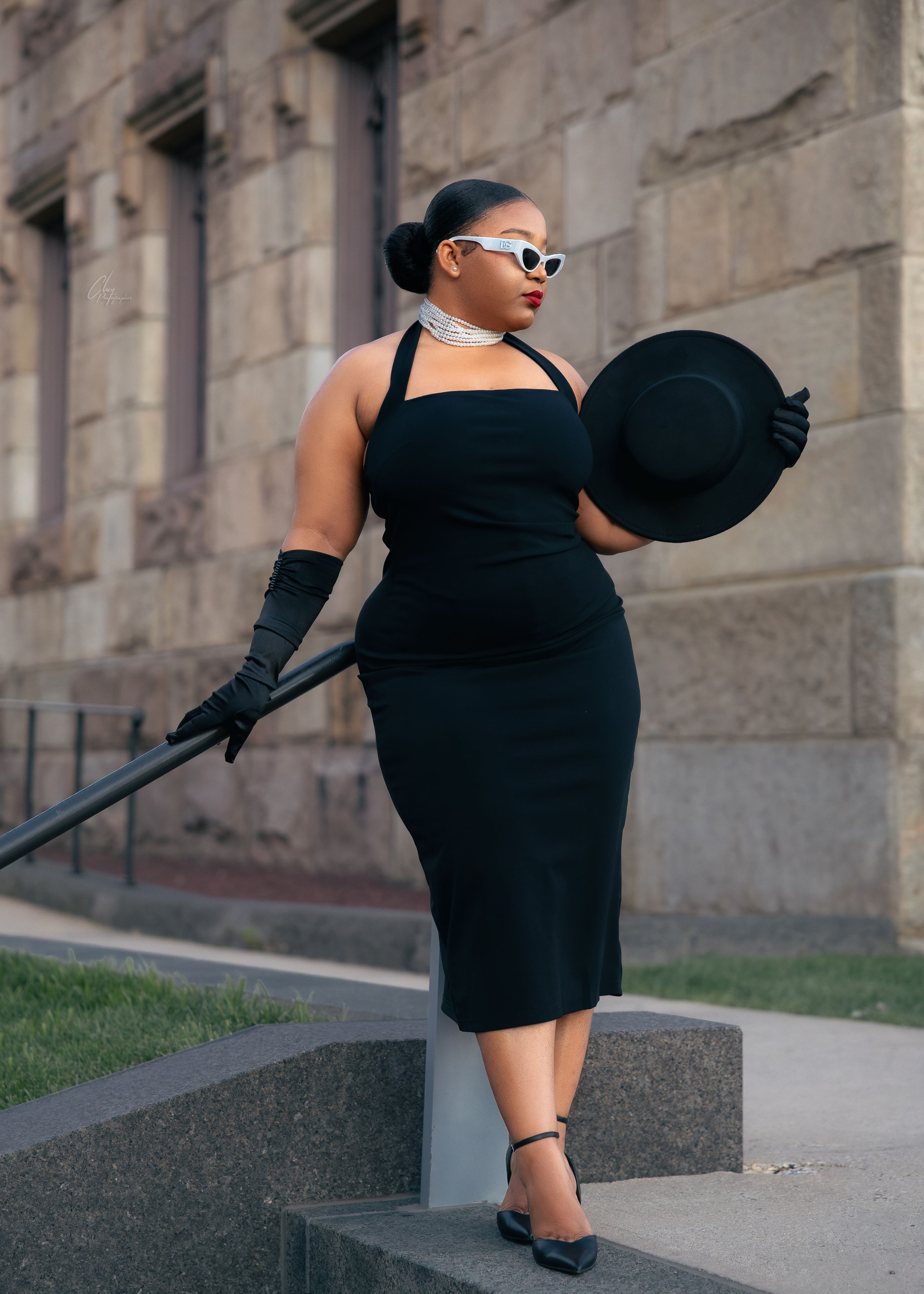 Portrait in black dress against stone columns