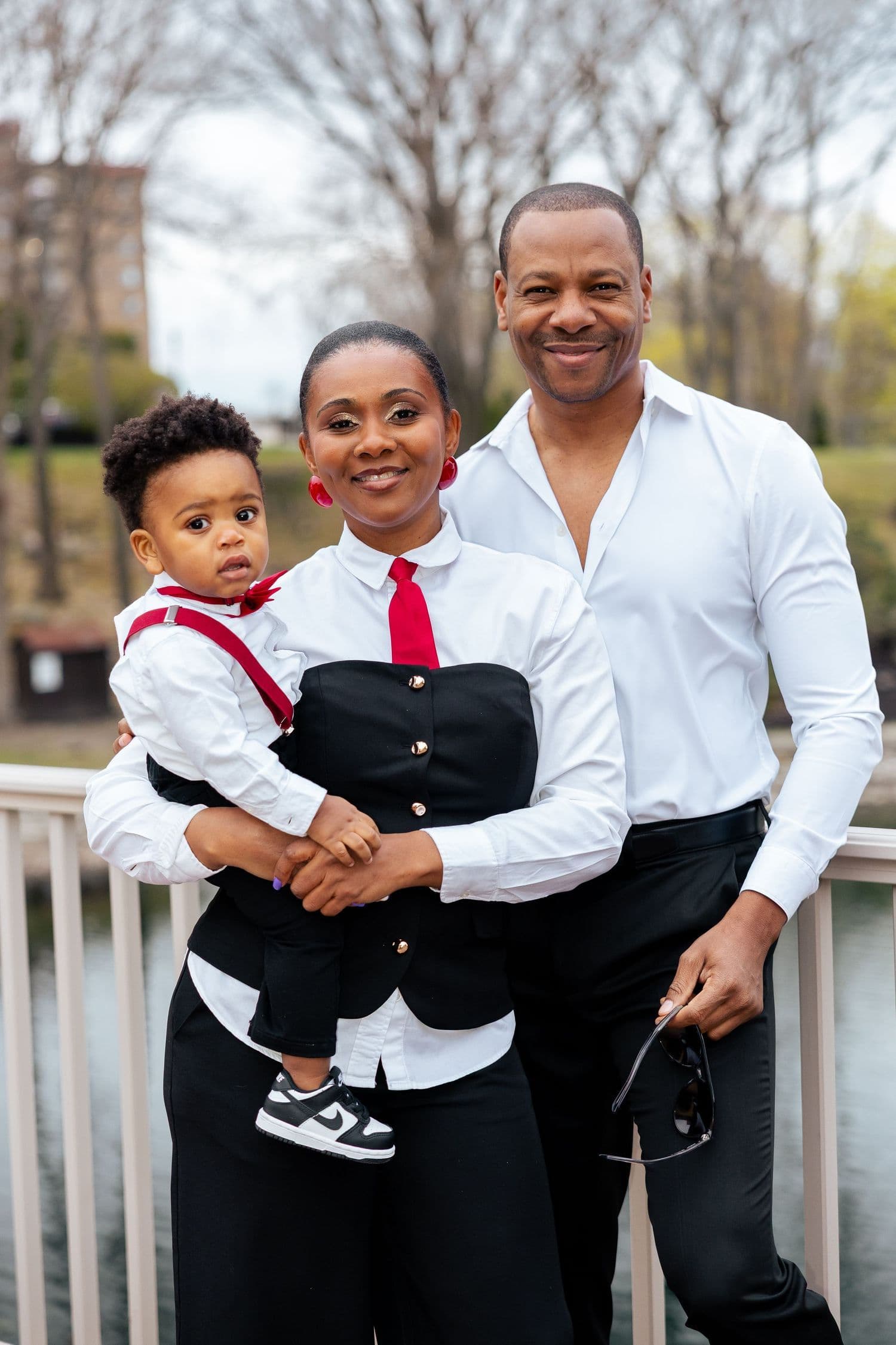 Family of three in coordinated black and white